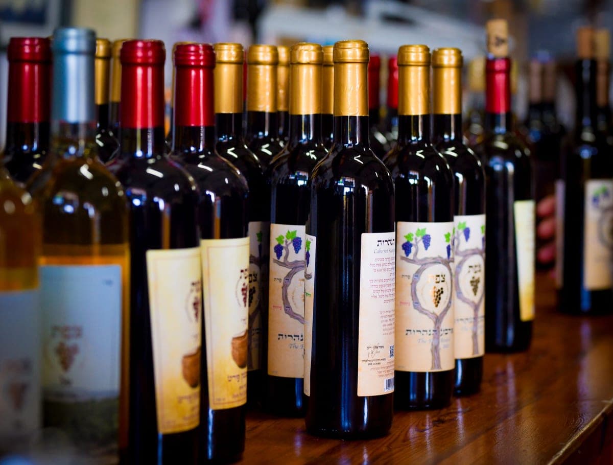 Red and white wine bottles standing together