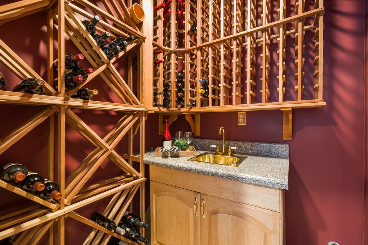 An indoor wine store with wooden racks and a stone countertop
