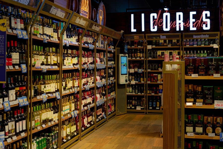 A freestanding floor wine rack holding bottles in a room